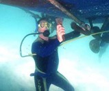Man Using Snorkel Hookah to Clean Boat Underside