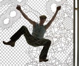 Man Climbing Lace Fence