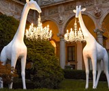 Life-Size Baby Giraffe Holding a Chandelier Light