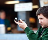 Guy Holding The Dot iPhone Panorama Lens