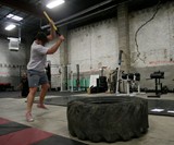 Guy in Pink Converse Swinging Sledgehammer